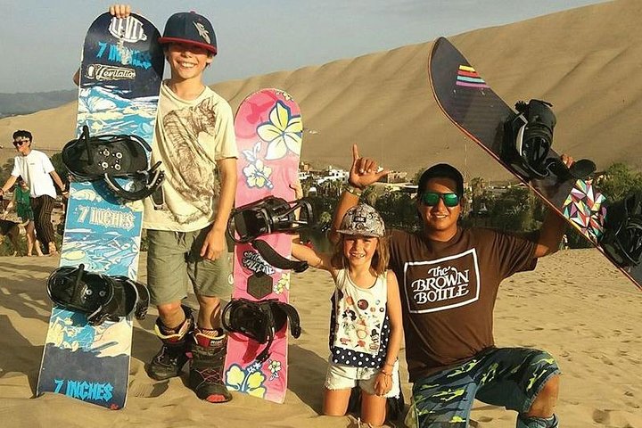 Sandboarding or Sand Ski in Huacachina Apresski bonfire Sunset