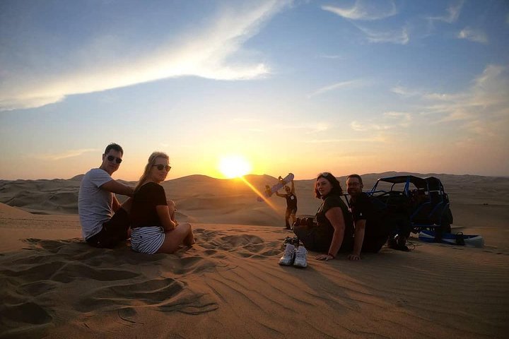 Sandboarding or Sand Ski in Huacachina Apresski bonfire Sunset