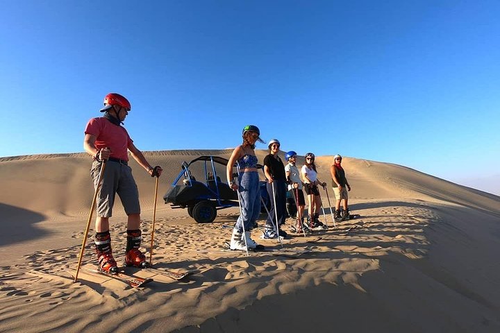 Sandboarding or Sand Ski in Huacachina Apresski bonfire Sunset
