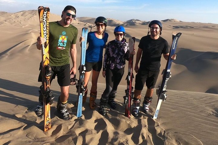 Sandboarding or Sand Ski in Huacachina Apresski bonfire Sunset