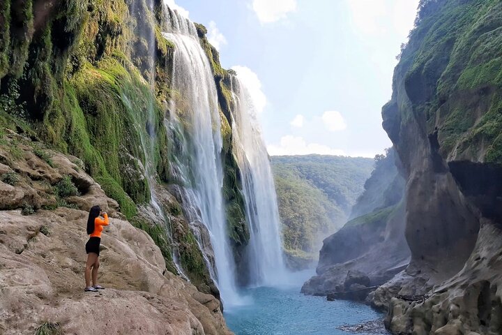 Tamul waterfall and water cave on a wooden canoe