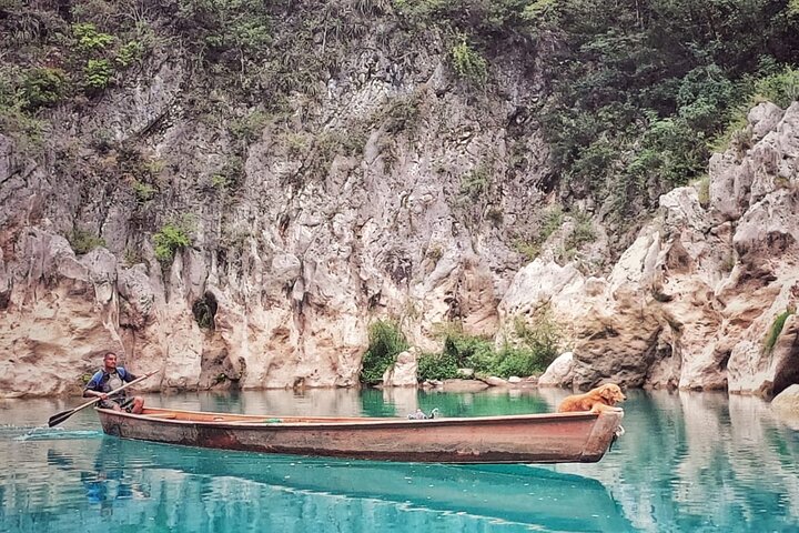 Tamul waterfall and water cave on a wooden canoe