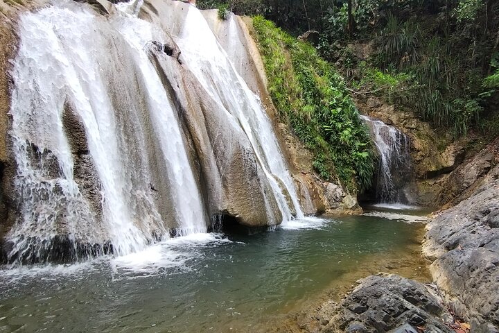 Natural adventure with waterfalls, trails and sunny day