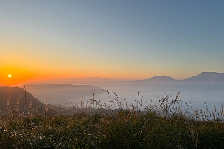View the sunrise and sea of clouds over the Aso Caldera