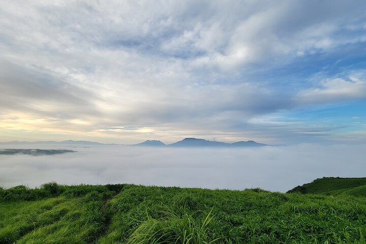 View the sunrise and sea of clouds over the Aso Caldera