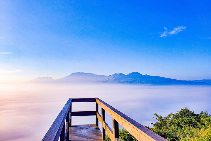 View the sunrise and sea of clouds over the Aso Caldera