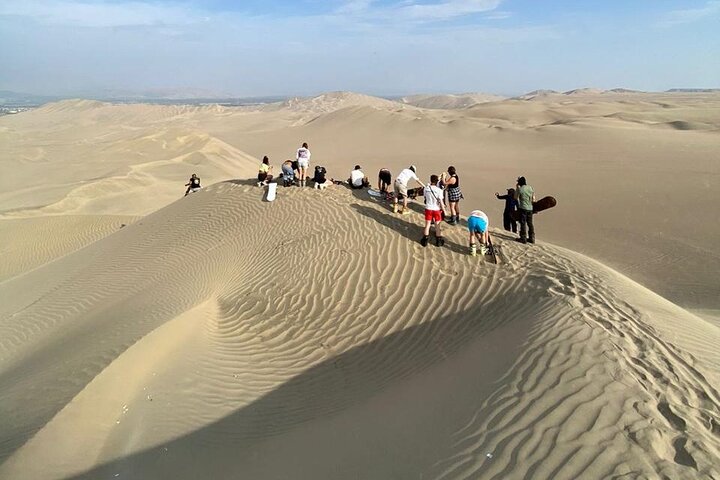 Sandboarding or Sand Ski in Huacachina Apresski bonfire Sunset