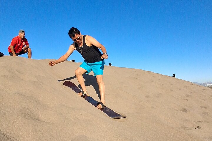 Sandboarding in the Mogote Sand Dunes in La Paz