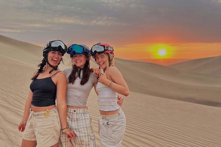 Sandboarding or Sand Ski in Huacachina Apresski bonfire Sunset