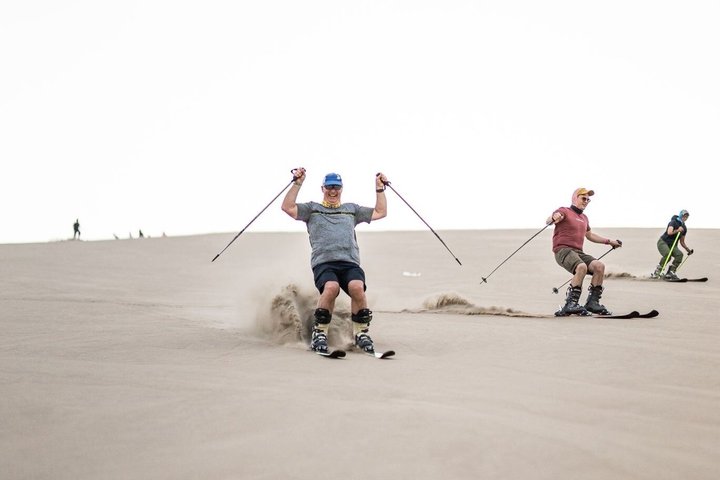 Sandboarding or Sand Ski in Huacachina Apresski bonfire Sunset