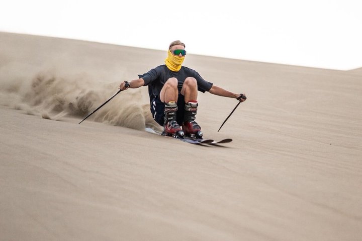 Sandboarding or Sand Ski in Huacachina Apresski bonfire Sunset